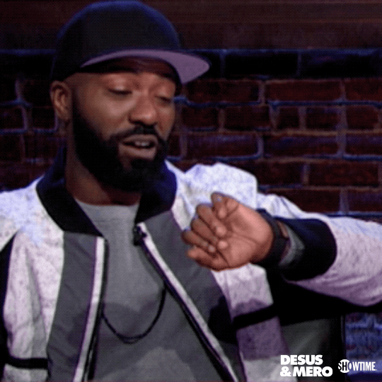 TV gif. Desus Nice from Desus & Mero looks at his watch on his wrist, rolls his eyes, and slides down in his seat in frustration.