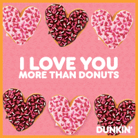 Sponsored gif. Alternating chocolate and pink heart-shaped donuts covered in sprinkles form two moving rows. The row on top moves to the left, while the row on the bottom moves to the right. Text between the two rows reads, “I love you more than donuts!”