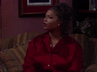 TV gif. Queen Latifah as Khadijah from Living Single looks pensive and slightly weirded out as she reacts to something offscreen.