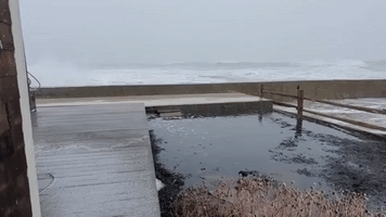 Waves Crash Over Wall in Brant Rock as Strong Winds Hit Massachusetts