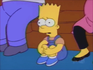 The Simpsons gif. Bart Simpson sits on the floor in between his parents who are sitting on the couch. Bart clings to his legs and shakily rocks back and forth. He has an empty stare that’s full of fear. 
