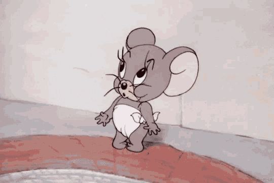 Cartoon gif. Nibbles from Tom and Jerry wears a diaper and points to his mouth, smacking his lips and then rubbing his belly.
