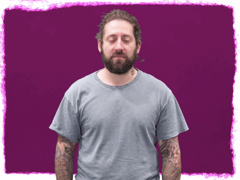 Celebrity gif. Joe Trohman from Fall Out Boy gives us a passionate, you-can-do-it look as he raises crossed fingers to eye level, wishing for the best. 