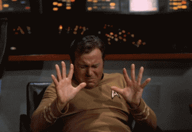 TV gif. William Shatner, as Captain Kirk in Star Trek closes his eyes and holds his hands out in an attempt to stop something. He opens his eyes and jumps in surprise.