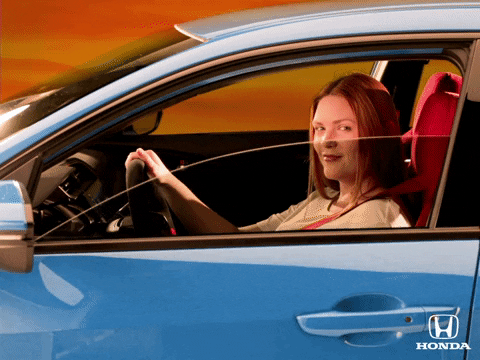 Video gif. A woman sits in the driver's seat of a car and tips her head back to say, "What's up?" as the window rolls down.