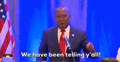 Video gif. Don Scott, a member of the Virginia House of Delegates, speaks into a microphone and points a finger down like he's emphasizing his words. Text, "We have been telling y'all."