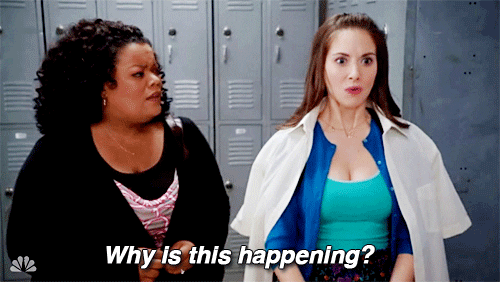 TV show gif. Yvette Nicole Brown as Shirley in Community looks on with concern while Alison Brie as Annie panics and asks, "Why is this happening?"