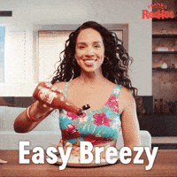 Sponsored gif. Smiling woman in a tropical floral crop top shakes Frank’s RedHot sauce onto a plate of shrimp and rice. A man dressed for the pool casually walks past her. Text reads, “Easy breezy.”