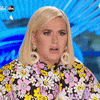 Video gif. Singer Katy Perry stares blankly, blinking slowly at an off-camera contestant during an episode of America's Got Talent.