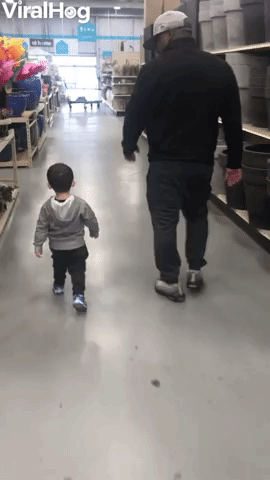 Little Boy Practices Walking Like Dad
