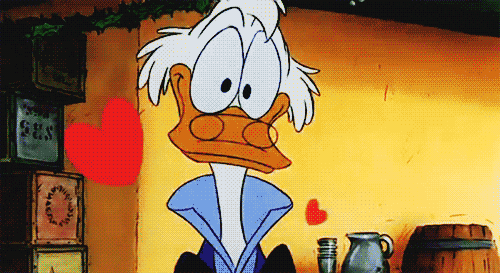 Cartoon gif. Scrooge McDuck looks disheveled and in love as he stares at us dopily and red hearts float up around him.