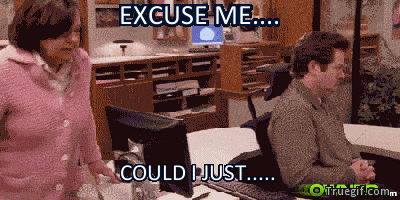 Parks and Recreation gif. Nick Offerman as Ron Swanson swirls around in his office chair, avoiding a woman chasing him around his circular desk. Text, "Excuse me... Could I just ..."