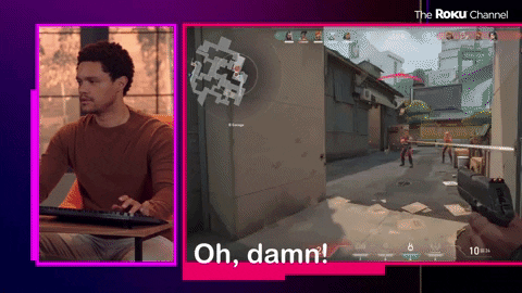 Celebrity gif. Split-screen of Trevor Noah playing the video game Valorant with his view of the screen on the right. Trevor's character gets killed in the game, and he says "Oh, damn!" although his expression remains unphased.