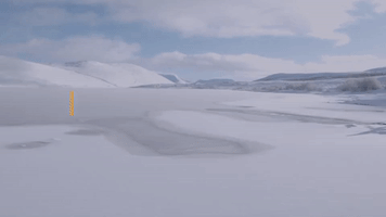 Swimmer Takes the Plunge Into Frozen Lake in Scottish Highlands