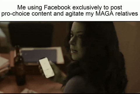 Video gif. Caption reads, “Me using Facebook exclusively to post pro-choice content and agitate my MAGA relatives.” Woman turns toward us and says, “I’m not proud of this.”