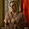 TV gif. Kara Killmer as Sylvie on Chicago Fire rubs her hands together as she smiles excitedly with her teeth clenched.