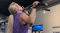 Woman Incorporates Wine Into Exercise Session