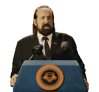 Sponsored sticker gif. Actor Peter Stormare speaks into microphones at a podium. Text reads, "Kick ass."