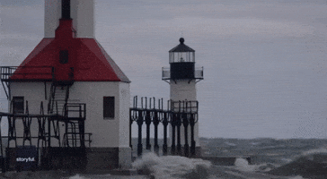 Waves Crash Against Michigan Lighthouse Amid Freezing Temperatures