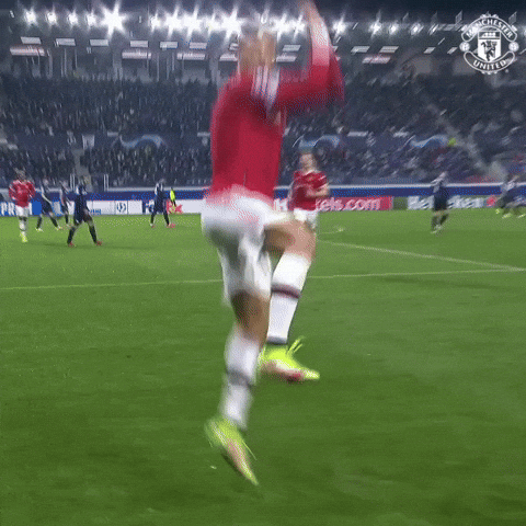 Sports gif. Cristiano Ronaldo in a flying jump, landing back to us in a dramatic stance.
