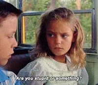Movie gif. In a scene from Forrest Gump, Jennie as a little girl sits next to Forest on a school bus looking genuinely confused and concerned, saying 