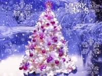 Video gif. Lights glitter on an image of a white flocked Christmas tree with fuschia ornaments. It stands at the edge of an icy lake with snow laden trees while glistening snowflakes hovering in the air. Text, 