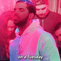 Music video gif. Young Drake is rapping in a club and there are people sitting around him, grooving and drinking. He says, 