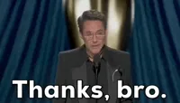 Oscars 2024 gif. Robert Downey Jr wins Best Supporting Actor. He quickly nods, raises his eyebrows and says with a deadpan expression, 