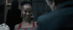 Movie gif. Zoe Saldana as Becky in Vampires vs. The Bronx. She grins and claps her hands together before doing a happy dance, spinning her arms and chest in a circle.