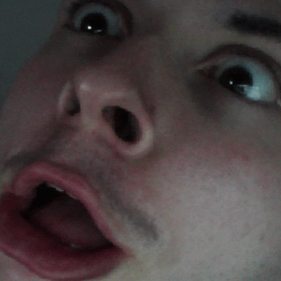 Photo gif. A shocked man with his jaw dropped and eyes wide glitches constantly up and down.