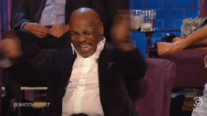 TV gif. From the Comedy Central Roast of Charlie Sheen: Mike Tyson claps, points offscreen, and laughs like crazy.