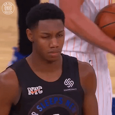 Sports gif. RJ Barrett looks side to side with a furrowed brow, perplexed, then blinks several times and raises his eyebrows.