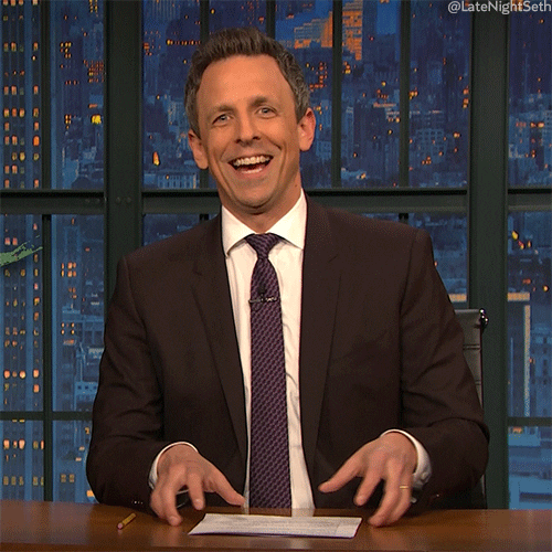 Late Night gif. Seth Meyers says yeah with a big grin on his face as he claps his hands in front of him.