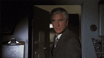 Movie gif. Leslie Nielsen as Dr. Rumack in Airplane steps into a cockpit and speaks to people inside. Text, "I just want to tell you all good luck. We're all counting on you."