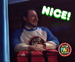 Video gif. A man has a big smile on his face gives two thumbs up. He has a big red pizza carrier on his lap. Text, “Nice!”