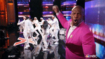 TV gif. Group of performers dance onstage on America's Got Talent, and Terry Crews looks at us, hooting and cheering them on from the side.