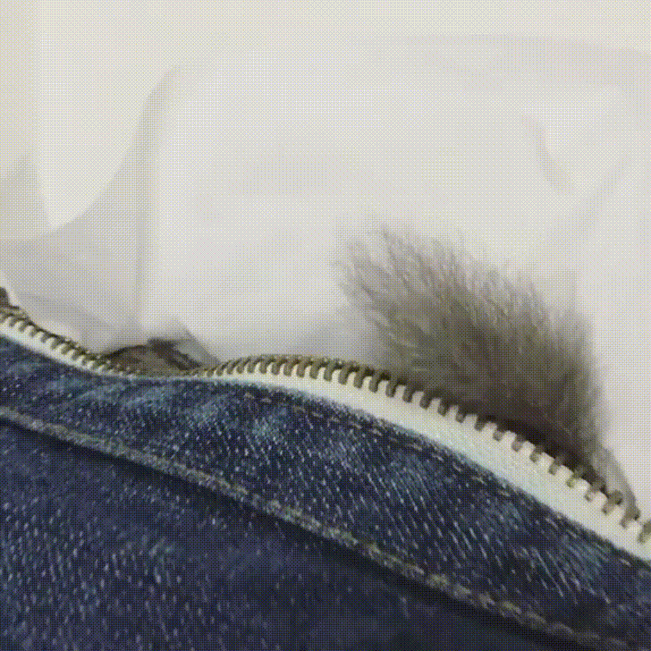 a close up of a zipper on a pair of jeans