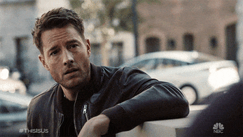 TV gif. Justin Hartley as Kevin Pearson on This Is Us, raising his eyebrows and pointing at himself.