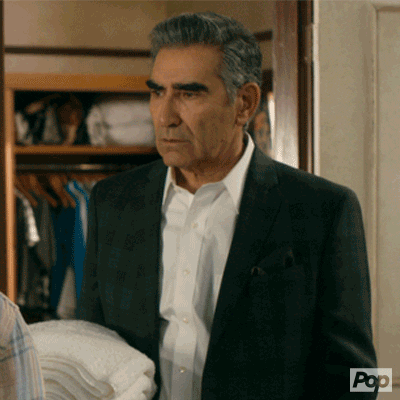 Schitt's Creek gif. Eugene Levy as Johnny Rose brings his hand to his face and turns away in exasperation.