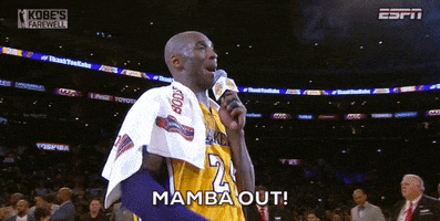 Sports gif. Video of Kobe Bryant standing on a basketball court wearing a Lakers jersey. He holds a microphone up to his mouth and kisses his fingers, sending them out into the stadium with a content smile. Text, "Mamba out!'