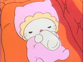 Cartoon gif. A baby hello kitty has her eyes closed as she sucks on a bottle in a bassinet. She wears a pink onesie and bonnet. 