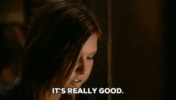 Reality TV gif. Audrina Patridge on The Hills has her cheeks stuffed with food and she chews as she says, “It’s really good.”