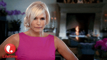 Celebrity gif. Yolanda Hadid reacts with disgust, sticking her tongue out as if she is gagging.