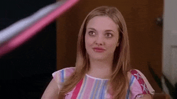 Movie gif. Amanda Seyfried as Karen in Mean Girls. She's listening to someone give a lecture and a scoff bursts out of her. She looks around and begins laughing and hanging her head.