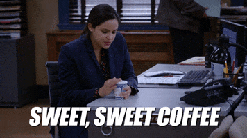 TV gif. Melissa Fumero as Amy Santiago on Brooklyn Nine Nine sitting at her desk and opening the lid of her coffee. Text, "Sweet, sweet coffee."
