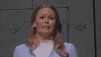 Movie gif. With a look of pure agony, Veronica Carlson as Anna in Frankenstein Must Be Destroyed fearfully slaps her hands upon her face and stressfully pulls back her skin.