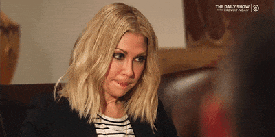 TV gif. Desi Lydic from The Daily Show with Trevor Noah bites her lips and closes her eyes in annoyance. She puts her head in her hand and looks very frustrated.