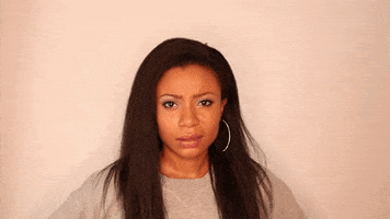 Celebrity gif. Shalita Grant looks at us with a sneer and we move to an extreme closeup of her face as she continues to make the same face. 