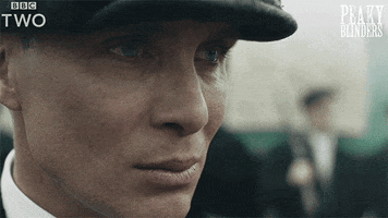 TV gif. Cillian Murphy as Thomas in Peaky Blinders. It's a close capture of his face and he looks incredibly tense as he stares into the distance. His eyes move around slowly, as he observes the scene around him, but the rest of his face remains impassive.