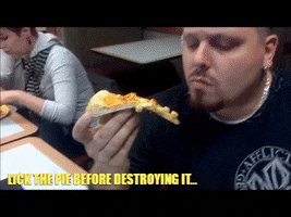 Video gif. Man holds a slice of pizza and gently tongues it before taking a bite. Text, "lick the pie before destroying it."